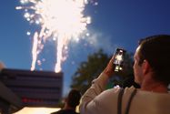 Ein Mann macht ein Foto von einem Feuerwerk